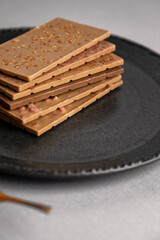 white chocolate pieces stacked over each other on plate. copy space text area