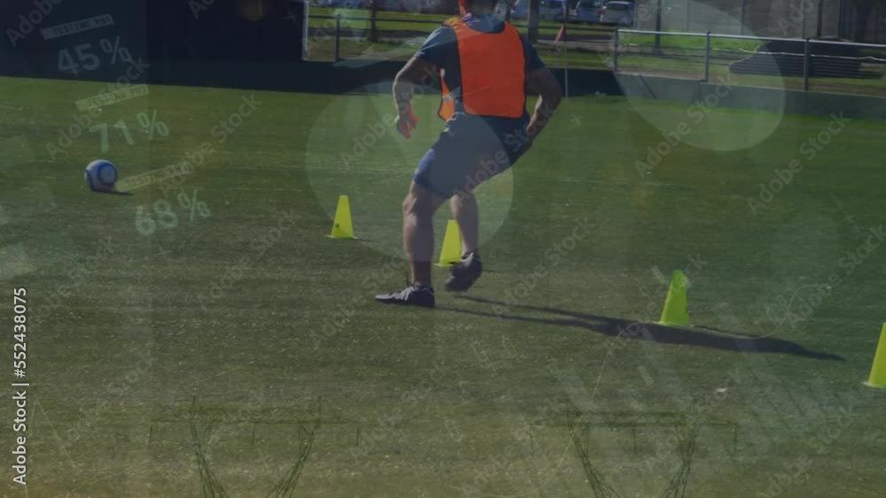 Poster animation of statistical data processing over male soccer player practicing soccer on sports field