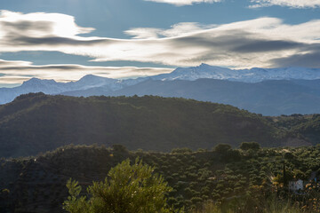 Beautiful lenticular clouds over the snowy peaks of Sierra Nevada (Granada, Spain)