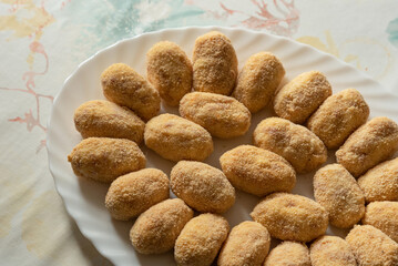 Dish of homemade croquettes ready to fry