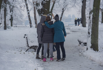 Happy girlfriends make selfie ат тhе park in winter. Belgrade, Kalemegdan park.