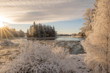 Fototapeta na wymiar Frosty cold winter day in a river landscape. Farnebofjarden national park in north of Sweden.