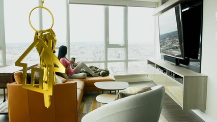 Animation of golden key and house over biracial woman in living room - Powered by Adobe