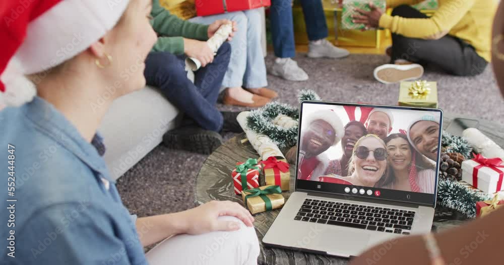 Canvas Prints Diverse friends with santa hats having laptop video call with happy diverse friends