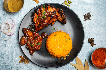 BBQ Tandoori Chicken and zyro or gyro rice food set with chili sauce served in a dish isolated on grey background top view of bangladesh food
