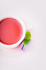 Fruit tea, blackberry macaron with mint leaf on pink background, copy space