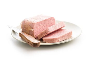 Luncheon meat on plate isolated on white background.