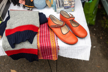 Red vintage shoes, scarf and sweater as interior decoration