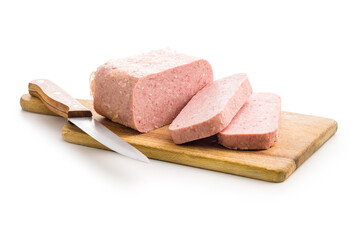 Luncheon meat on cutting board isolated on white background.