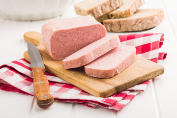 Luncheon meat on cutting board.