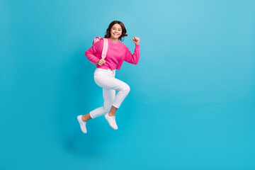 Fototapeta na wymiar Full length photo of pretty hurrying girl dressed knit pullover jumping high running lessons empty space isolated blue color background