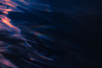 Blur colorful warm pink rainbow light leaks on black background. Defocused abstract analog retro film lens flare bokeh overlay or screen filter effect. Glow Vintage prism, water caustic, surreal light