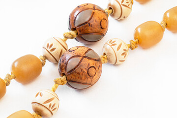Close-up of wooden beads with mother-of-pearl on an antique handmade necklace