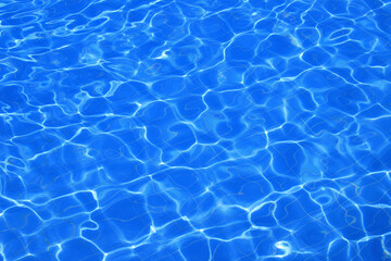 Sunlight shining on a blue swimming pool