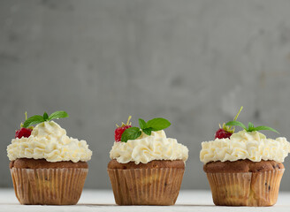 Baked cupcakes with white butter cream on the table, delicious dessert