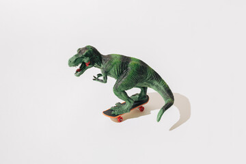 Tyrannosaurus rex on skateboard. White background.