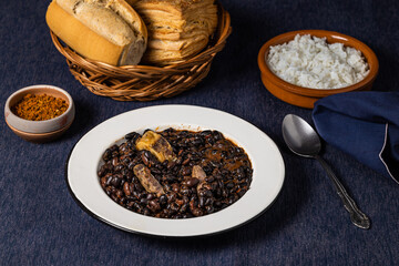 Beans and pork, typical Brazilian food, along with rice and bread.