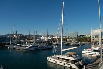 Fototapeta na wymiar Boats and yachts moored in the harbor bay on a calm winter day