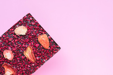 Handmade chocolate with red berries on pink background