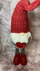 a christmas decoration elf, gnome in an old red sock, winter, new year and holiday concept.