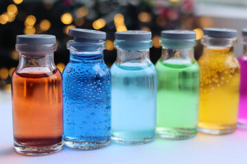 Glass jars with colored solutions of indicator dyes.