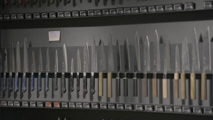 This panning video shows a large collection of hand made Japanese chef knives.