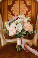 beautiful wedding bouquet of the bride on a beautiful chair in the hotel
