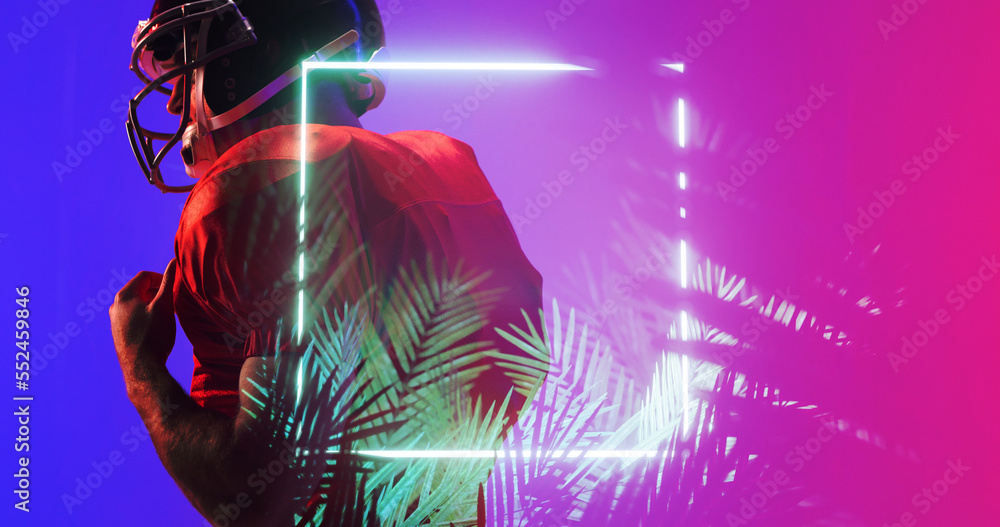 Poster side view of american football player in red uniform and helmet by illuminated square and plants