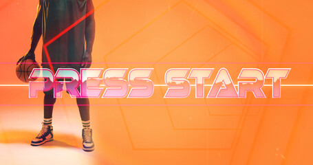 Low section of african american basketball player with ball standing by press start and lines