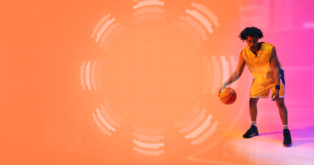 Naklejka premium Composite of biracial basketball player dribbling ball by floral pattern, copy space