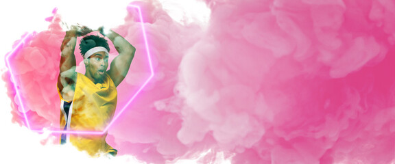 Composite of biracial male player taking shot with basketball by hexagon over smoky background