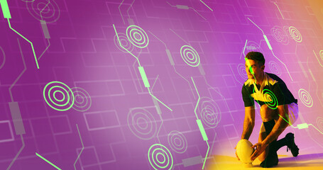 Caucasian rugby player placing ball on stand over illuminated circles and grid pattern
