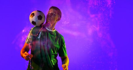 Caucasian soccer player practicing with ball and abstract design over blue background, copy space © vectorfusionart