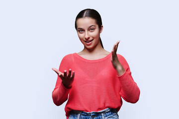 Emotional laughing young female student on white background