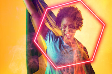 Hexagon neon over cheerful african american fan with flag celebrating success during soccer match