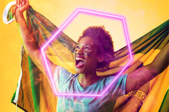 Hexagon neon over cheerful african american fan with flag celebrating victory during soccer match