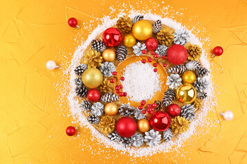 Naklejka na ściany i meble Christmas wreath on a golden background