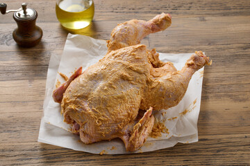 raw chicken covered with spicy butter