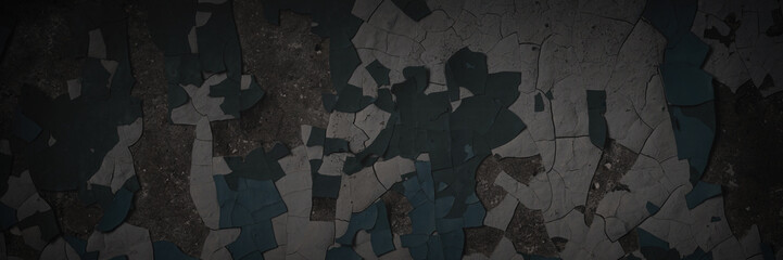 Obraz premium Dark wide panoramic background. Peeling paint on a concrete wall. Dark grunge texture of old cracked flaking paint. Weathered rough painted surface. Patterns of cracks. Darkness background for design.