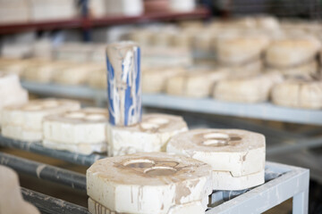 Gypsum molds for casting ceramic utensils in workshop of a pottery factory