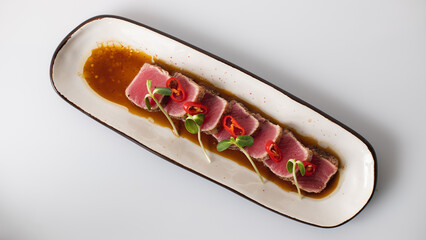 Tuna sashimi on a gray background. Service. Waiter. Banquet