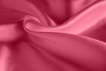 Fototapeta premium Viva Magenta silk background texture, abstract pattern for design. Sample of the color of the 2023 year.