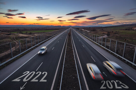 Driving On Open Road At Beautiful Sunny Day To New Year 2023. Aerial View Of Travel And Transportation On Highway. 