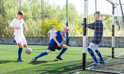 Teens playing soccer football match. Competition between two youth soccer teams. Football soccer...