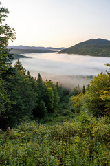 Fototapeta na wymiar Mist covers the valley along the Maine Quebec international border