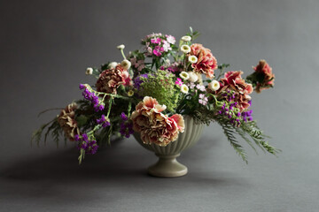Still life image of a floral arrangement in a green vase, no people