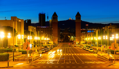 Fototapeta na wymiar Urbanscape of Placa d'Espanya in Barcelona with view of twin Venetian Towers and fountain at centre of square.