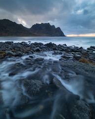 Obraz premium Small river flowing at Unstad beach, Lofoten Islands, Norway