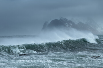 Storm wind blows sea spray off waves, Lofoten Islands, Norway