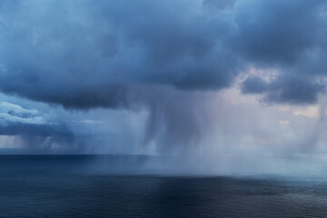 Spring snow flurries fall over sea, Lofoten Islands, Norway